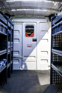 Interior of a van that has been outfitted with Knapheide Van Equipment shelving and partitions