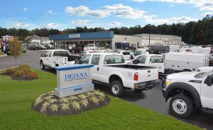 Dejana Truck and Utility Equipment trucks parked in front of building