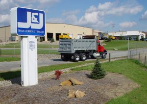 J and J Truck Equipment sign and truck in front of building